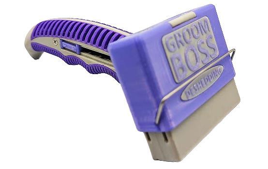 GroomBoss self-cleaning de-shedding brush with a purple ergonomic handle